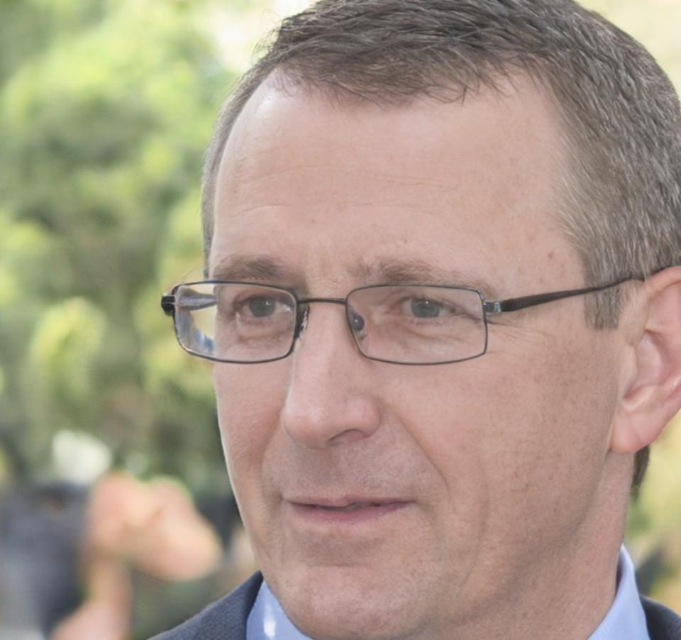 Senior network engineer reviewing distributed system architecture